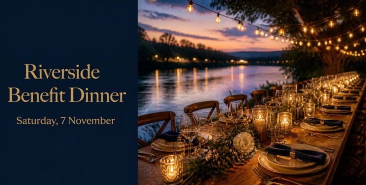 Invitation card for the Riverside Benefit Dinner on Saturday, 7 November: a candlelit table by a river at dusk.